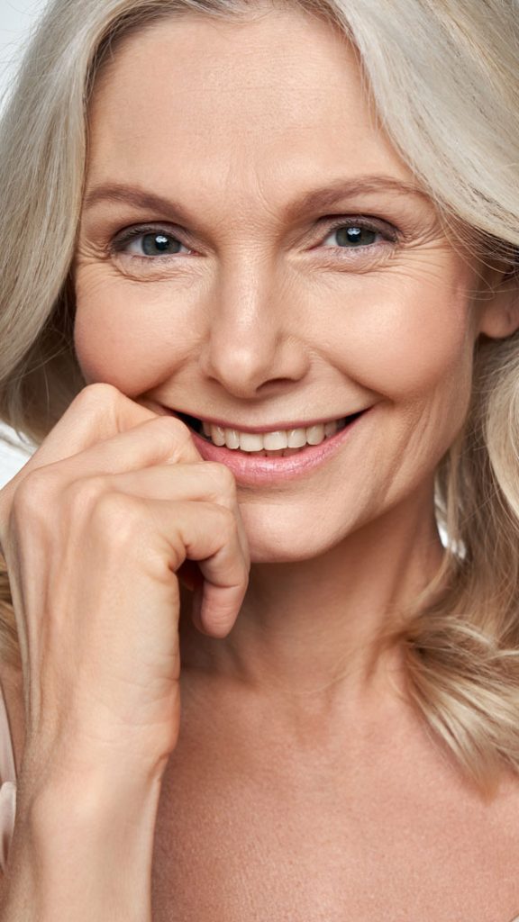 Picture of a Middle Age Woman Smiling after Botox Treatment
