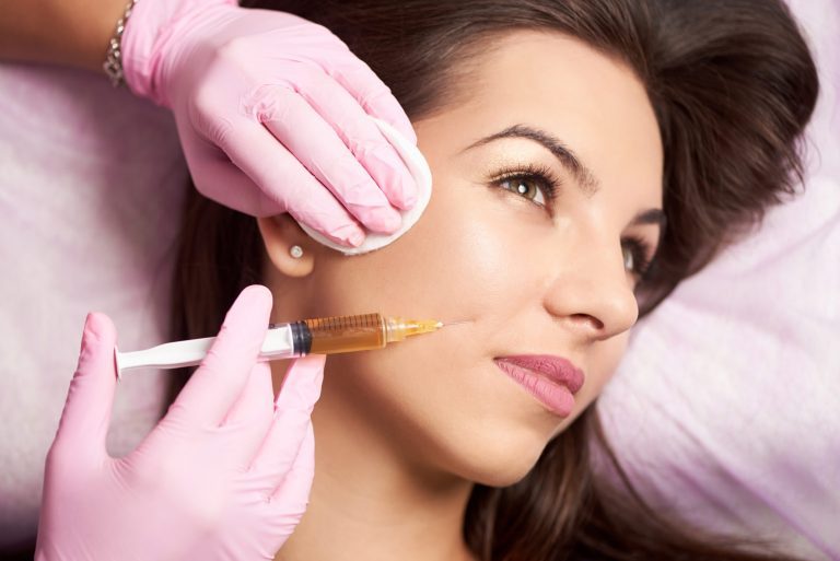 Woman being applied of filler injection to describe restylane application